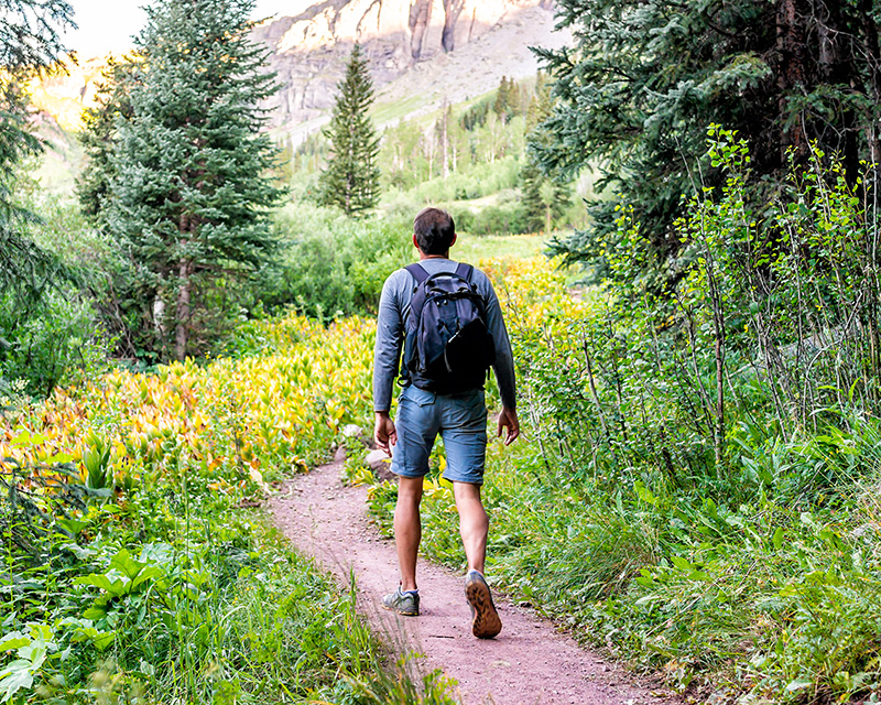 Young man walking on a path toward individual therapy in New York